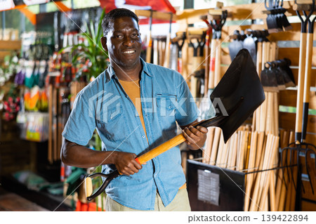 Portrait of an african american man choosing working tools Portrait of an african american man choosing working tools 139422894