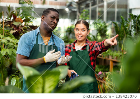 African american greenhouse owner and female worker talking African american greenhouse owner and female worker talking 139423070