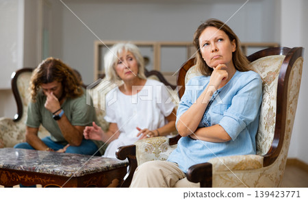 Domestic quarrel relatives in apartment. Adult offended woman turned away 139423771