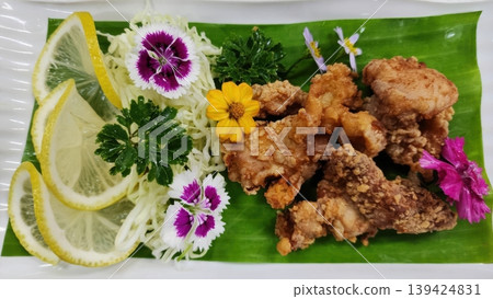 Gourmet Japanese Karaage Fried Chicken with Lemon and Edible Flowers 139424831