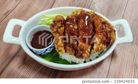 Japanese Tonkatsu Crispy Breaded Pork Cutlet Served Over White Rice with Savory Sauce Japanese Tonkatsu Crispy Breaded Pork Cutlet Served Over White Rice with Savory Sauce 139424833