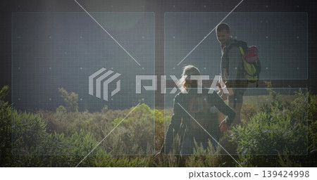 Helping woman climbing sunlit hillside brush by man reaching back, with hiking backpacks and boots Helping woman climbing sunlit hillside brush by man reaching back, with hiking backpacks and boots 139424998