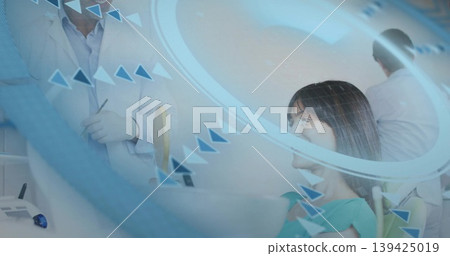 Dentist examining patient wearing green bib in dental chair at clinic room, with digital overlay Dentist examining patient wearing green bib in dental chair at clinic room, with digital overlay 139425019