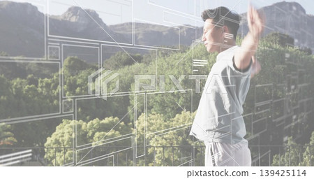 Standing adult Asian man raising arms on balcony railing, using UI overlays, copy space 139425114