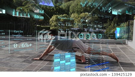Maintaining plank pushup Asian man in sportswear on terrace with glass railing, financial overlays 139425129