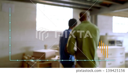 Inspecting colleagues wearing green and blue shirts in workshop with wooden drawers, data overlay 139425156