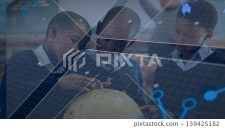 Pointing students in navy uniforms exploring globe in classroom, with holographic grid Pointing students in navy uniforms exploring globe in classroom, with holographic grid 139425182