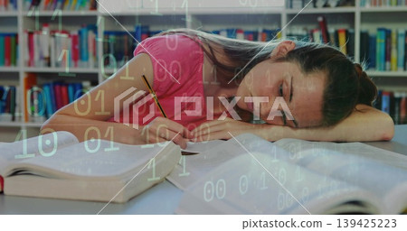 Studying teenage student writing in notebook at library table, with textbooks pencil binary overlay Studying teenage student writing in notebook at library table, with textbooks pencil binary overlay 139425223
