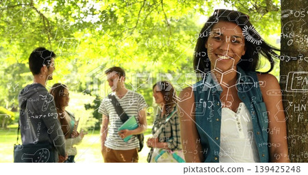 Leaning female student smiling against tree trunk on campus lawn, with notebooks, copy space Leaning female student smiling against tree trunk on campus lawn, with notebooks, copy space 139425248