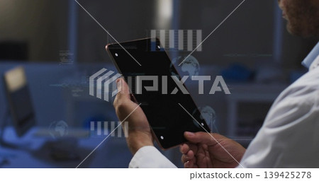 Scientist holding tablet in lab coat exploring holographic overlay with monitors in research lab Scientist holding tablet in lab coat exploring holographic overlay with monitors in research lab 139425278