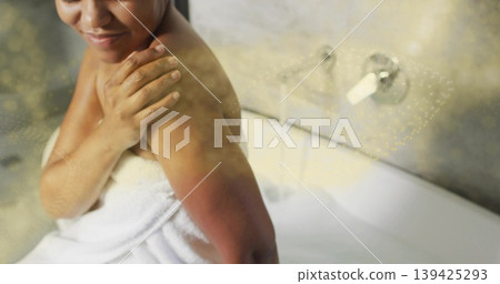 Wrapping towel around torso, woman bathing in spa bathtub with foam and chrome faucet, copy space Wrapping towel around torso, woman bathing in spa bathtub with foam and chrome faucet, copy space 139425293
