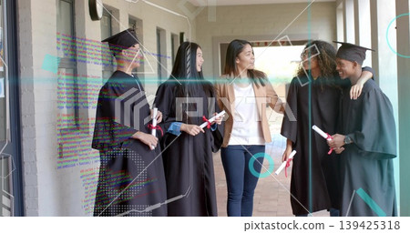 Celebrating mentor and graduates wearing black gowns on campus walkway, holding red ribbon diplomas Celebrating mentor and graduates wearing black gowns on campus walkway, holding red ribbon diplomas 139425318