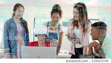 Teenage boy wearing VR headset operating laptop in classroom workspace, with green binary overlay Teenage boy wearing VR headset operating laptop in classroom workspace, with green binary overlay 139425350