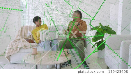 Collaborating friends using smartphone, laptop in living room with coffee table and digital overlay Collaborating friends using smartphone, laptop in living room with coffee table and digital overlay 139425408