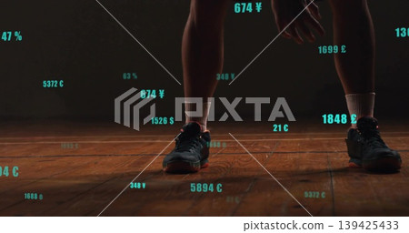 Standing athlete wearing black sneakers and white socks on arena court with teal numeric overlays 139425433