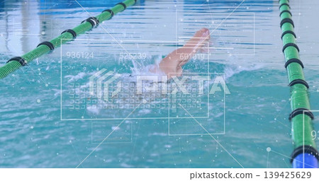Male swimmer performing crawl in lap pool with green black lane ropes and digital HUD overlays Male swimmer performing crawl in lap pool with green black lane ropes and digital HUD overlays 139425629