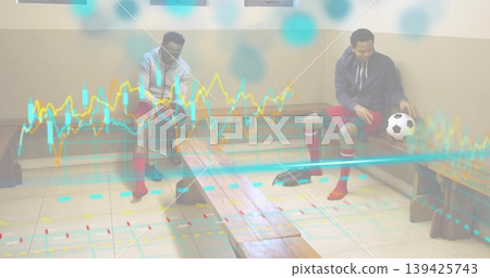 Sitting two men tying cleats and holding soccer ball in sports locker room, with chart overlay 139425743