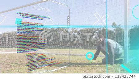 Kneeling athlete wearing sportswear at soccer goal net showing AI DATA MINING overlays, copy space 139425744
