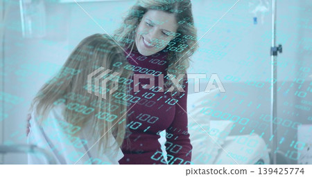 Mother in maroon sweater and daughter sharing hug in hospital room beside bed and IV stand Mother in maroon sweater and daughter sharing hug in hospital room beside bed and IV stand 139425774