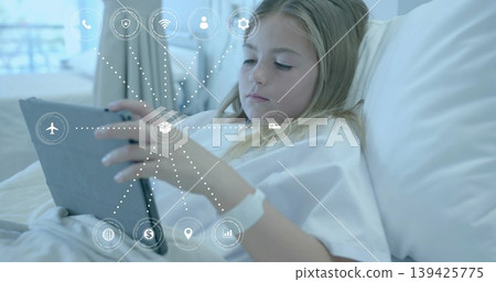 Girl wearing gown holding tablet on hospital bed, with floating digital service icons, copy space Girl wearing gown holding tablet on hospital bed, with floating digital service icons, copy space 139425775