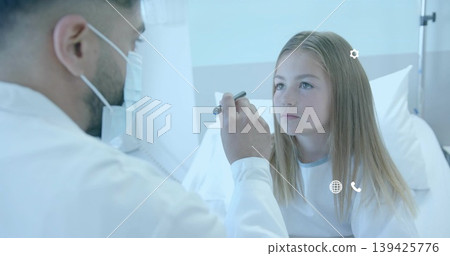 Examining doctor shining penlight into patient wearing hospital gown on hospital bed, copy space Examining doctor shining penlight into patient wearing hospital gown on hospital bed, copy space 139425776