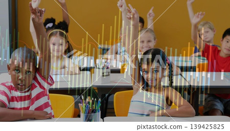 Eight elementary students raising hands in classroom, with colored pencils on white desks Eight elementary students raising hands in classroom, with colored pencils on white desks 139425825
