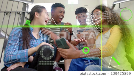 Teenage friends sharing smartphone screen in stairwell, with augmented reality code overlays Teenage friends sharing smartphone screen in stairwell, with augmented reality code overlays 139425899