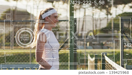 Standing tennis player in white gear smiling by net on court at sunset, with data overlays 139425968