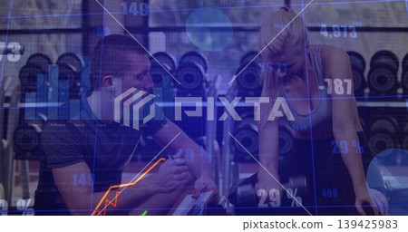 Displaying overlay trainer guiding client lifting dumbbell at bench by rack in gym, with tablet Displaying overlay trainer guiding client lifting dumbbell at bench by rack in gym, with tablet 139425983