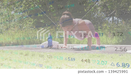 Performing push-ups woman wearing pink top on platform in park with water bottle and exercise towel Performing push-ups woman wearing pink top on platform in park with water bottle and exercise towel 139425991