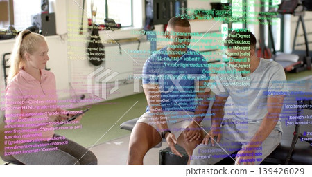 Talking three gym-goers sitting at gym bench, woman in pink pullover, code overlay Talking three gym-goers sitting at gym bench, woman in pink pullover, code overlay 139426029