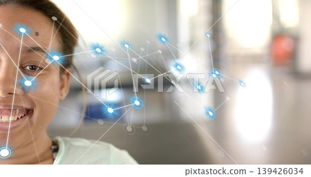 Smiling woman wearing light top and small necklace in bright lobby blue network overlay, copy space Smiling woman wearing light top and small necklace in bright lobby blue network overlay, copy space 139426034