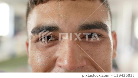 Looking adult male making direct eye contact at bright open hall, with numeric graphical overlay 139426035