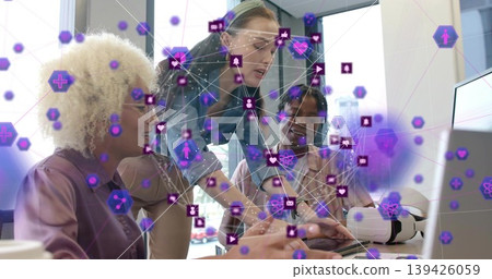 Working three adults pointing and typing at laptop in office, mauve blouse and purple AR overlay Working three adults pointing and typing at laptop in office, mauve blouse and purple AR overlay 139426059