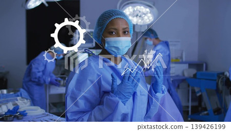 Raising gloved hands female surgeon preparing for surgery in operating room, with digital overlay Raising gloved hands female surgeon preparing for surgery in operating room, with digital overlay 139426199