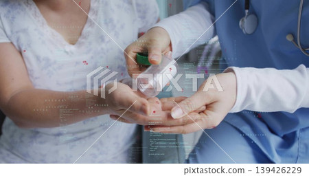Medic in blue scrubs with stethoscope pouring pills from white bottle at clinic, with floating data Medic in blue scrubs with stethoscope pouring pills from white bottle at clinic, with floating data 139426229