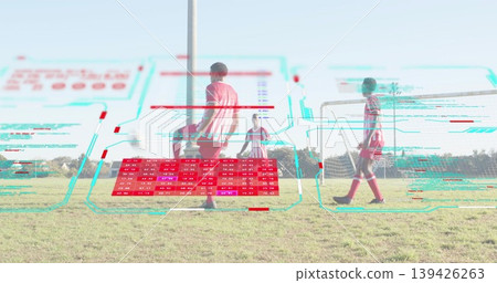 Preparing player in striped jersey controlling soccer ball in park field with goal and HUD overlay 139426263