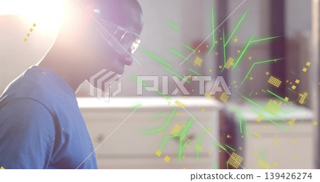 Technician wearing protective goggles examining floating holographic interface in lab, copy space Technician wearing protective goggles examining floating holographic interface in lab, copy space 139426274