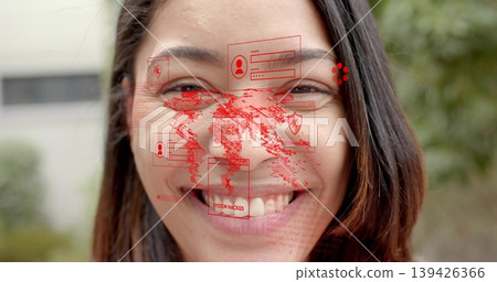 Smiling adult female displaying red world map, login boxes, SYSTEM HACKED alerts outdoors Smiling adult female displaying red world map, login boxes, SYSTEM HACKED alerts outdoors 139426366