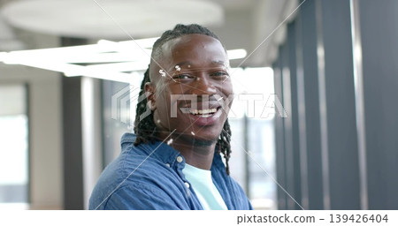 Standing man wearing denim shirt and T-shirt in modern office corridor, with circular lights Standing man wearing denim shirt and T-shirt in modern office corridor, with circular lights 139426404