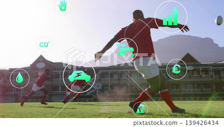 Winding up male soccer player kicking soccer ball on grass pitch, with AR data icons Winding up male soccer player kicking soccer ball on grass pitch, with AR data icons 139426434