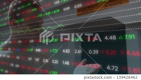 Male in dark shirt analyzing data on transparent screen in office, with colored arrows, jagged line Male in dark shirt analyzing data on transparent screen in office, with colored arrows, jagged line 139426462