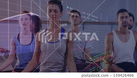 Meditating group of six wearing athletic apparel on yoga mats in studio, with financial overlays Meditating group of six wearing athletic apparel on yoga mats in studio, with financial overlays 139426466