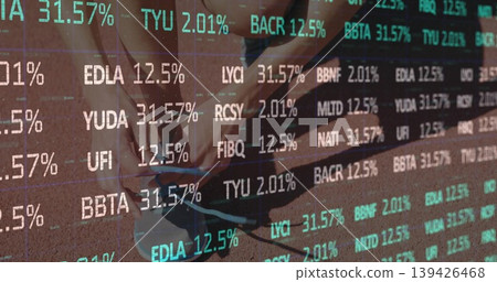 Crouching runner tying grey-blue running shoe laces on red track with financial ticker overlay Crouching runner tying grey-blue running shoe laces on red track with financial ticker overlay 139426468