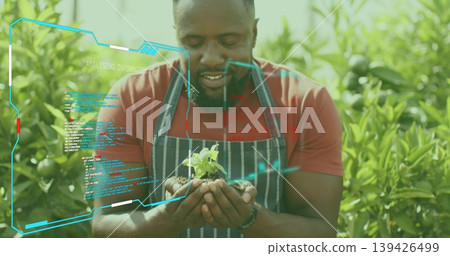 Man in red t-shirt and apron inspecting seedling in outdoor nursery, with holographic UI overlay Man in red t-shirt and apron inspecting seedling in outdoor nursery, with holographic UI overlay 139426499