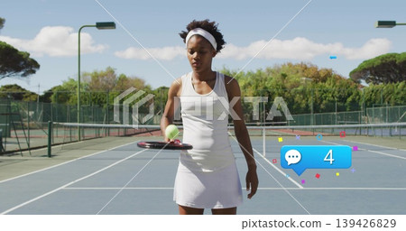 Balancing ball on racket by tennis player near service line on blue court, featuring chat alert 139426829