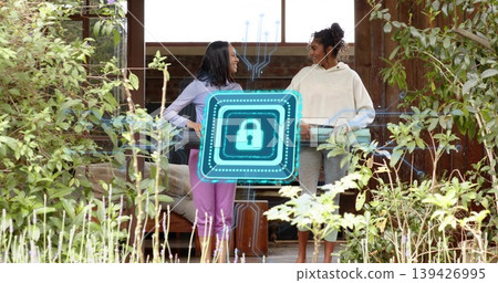 Standing two women talking and leaning on wooden porch railing, with holographic padlock overlay Standing two women talking and leaning on wooden porch railing, with holographic padlock overlay 139426995