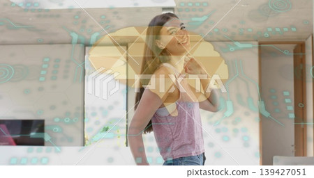 Smiling woman wearing pink top, blue jeans standing in living room, with TV and AR overlays Smiling woman wearing pink top, blue jeans standing in living room, with TV and AR overlays 139427051
