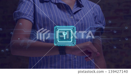 Extending female torso and arms wearing blue striped shirt in studio, using smartwatch holo key UI Extending female torso and arms wearing blue striped shirt in studio, using smartwatch holo key UI 139427140