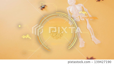 Displaying holographic circle with molecular cluster on orange table, skeleton toy and spiders Displaying holographic circle with molecular cluster on orange table, skeleton toy and spiders 139427190